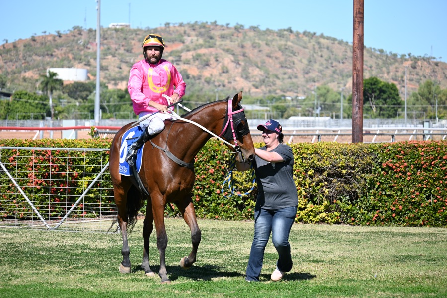 An elated Holly Robertson with jockey James Baker and gelding Mishani Eagle at Buchanan Park after her first win on June 29, 2024.
