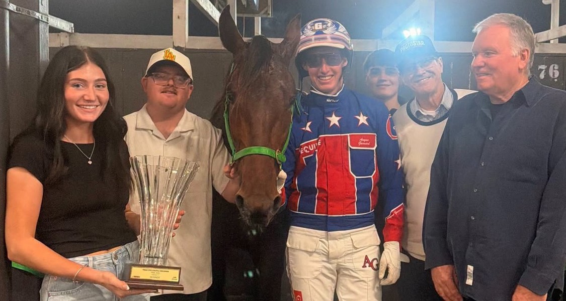 Angus Garrard alongside connections after handing Donny Smith a Group 1 win with Pure Grunt.