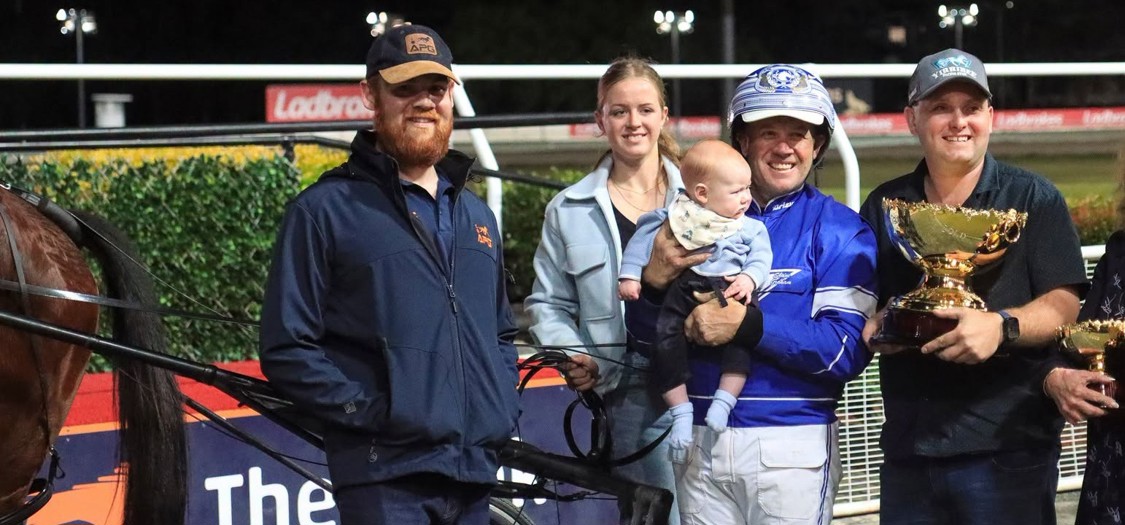 Trainer and driver Kelli Dawson with son Jackson and other connections after Saturday's win.