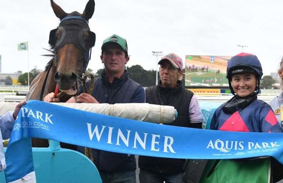 The Stephanie Sixtus stable celebrate a win from Shooting Firm with hoop Jett Newman.